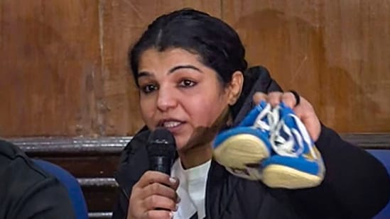 Wrestler Sakshi Malik hangs up boots during a press conference as she announces her retirement from the sport, protesting against Brij Bhushan Sharan Singh loyalist Sanjay Singh winning the Wrestling Federation of India (WFI) election for its presidential post, in New Delhi, Thursday, Dec. 21, 2023. Wrestler Sakshi Malik hangs up boots during a press conference as she announces her retirement from the sport, protesting against Brij Bhushan Sharan Singh loyalist Sanjay Singh winning the Wrestling Federation of India (WFI) election for its presidential post, in New Delhi, Thursday, Dec. 21, 2023.