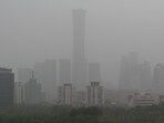 High rise buildings at central business district are seen on a severely polluted day in Beijing on April 12, 2023.(AFP)