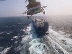 Houthi military helicopter flies over the Galaxy Leader cargo ship in the Red Sea in this photo released November 20, 2023.
