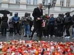 Czech Prime Minister Petr Fiala lays flowers at an impromptu memorial outside Charles University in central Prague. The government announced a day of national mourning, with flags to be flown at half-mast and a minute's silence to be observed at noon on December 23.&nbsp;