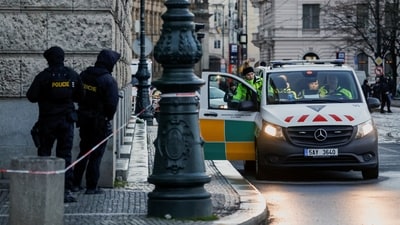 The Czech Republic Police identified the assailant as 24-year-old student David Kozak, a student of Polish history at Prague's Charles University. In the picture, police officers are on guard while a policewoman enters a police vehicle post the shooting incident.&nbsp; (REUTERS)
