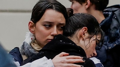 People gather at a memorial vigil held to pay tribute to the victims following the unprecedented shooting at Charles University in Prague. (REUTERS)