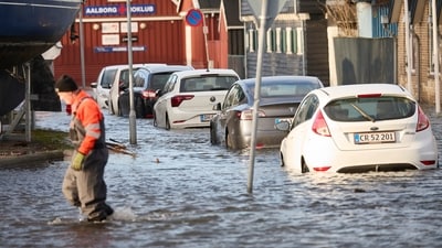 Cars stand in water on the Aalborg harbor front, North Jutland, Denmark on Friday. (AP) Cars stand in water on the Aalborg harbor front, North Jutland, Denmark on Friday. (AP)
