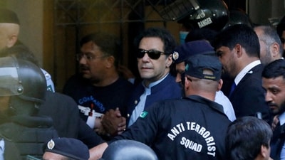 Security officers escort Pakistan's former prime minister Imran Khan, as he appeared in Islamabad High Court. (Reuters)