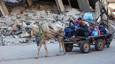 Residents of the refugee camp of Bureij arrive in Deir al-Balah in the central Gaza Strip (AFP)