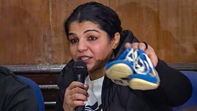 Wrestler Sakshi Malik hangs up boots during a press conference as she announces her retirement from the sport, protesting against Brij Bhushan Sharan Singh loyalist Sanjay Singh winning the Wrestling Federation of India (WFI) election for its presidential post, in New Delhi, Thursday, Dec. 21, 2023. (PTI) Wrestler Sakshi Malik hangs up boots during a press conference as she announces her retirement from the sport, protesting against Brij Bhushan Sharan Singh loyalist Sanjay Singh winning the Wrestling Federation of India (WFI) election for its presidential post, in New Delhi, Thursday, Dec. 21, 2023. (PTI)