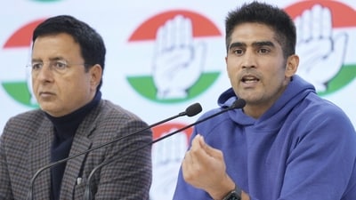Congress leader and boxer Vijender Singh with party leader Randeep Surjewala addresses a press conference at AICC headquarters, in New Delhi, Friday, Dec. 22, 2023. (PTI)