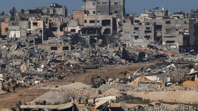 An Israeli army tank rolling past debris of buildings in the Gaza Strip amid ongoing battles with the Hamas militant group. (AFP)