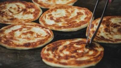 Parathas: For the north Indians, paratha is not just a dish but an emotion. You can find them anywhere in the streets of Delhi-NCR. In fact there is a lane just dedicated to parathas. Hot parathas with a cup of tea is the perfect combination in the winters. (Unsplash) Parathas: For the north Indians, paratha is not just a dish but an emotion. You can find them anywhere in the streets of Delhi-NCR. In fact there is a lane just dedicated to parathas. Hot parathas with a cup of tea is the perfect combination in the winters. (Unsplash)