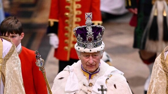 Britain's King Charles III wearing the Imperial state Crown leaves Westminster Abbey after the Coronation ceremonies. (AFP)