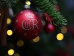 Christmas decorations, including a bauble featuring the cypher of King Charles III, are pictured on the Downing Street Christmas tree in central London. Christmas decorations, including a bauble featuring the cypher of King Charles III, are pictured on the Downing Street Christmas tree in central London.