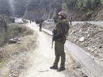 Army personnel stand guard near the site where two Army vehicles were ambushed by terrorists on Thursday in Poonch district, Army personnel stand guard near the site where two Army vehicles were ambushed by terrorists on Thursday in Poonch district,