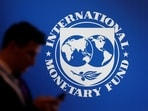 A man walks past the IMF banner.