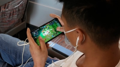 A man plays an online game from Chinese gaming platform Tencent on a train. (AP) A man plays an online game from Chinese gaming platform Tencent on a train. (AP)