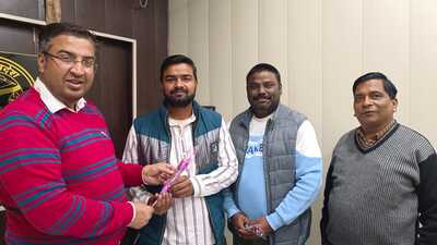 District social welfare officer Sudhanshu Shekhar Pandey with Nazmul Hasan Ansari after the latter clears PCS Mains, in Lakhimpur on Saturday. (Sourced)