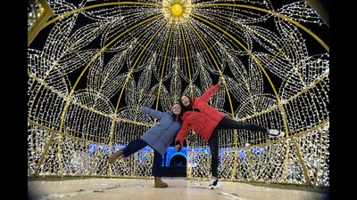 FESTIVE CHEER: A mother-daughter duo pose at a decorated park ahead of New Year. (AP) FESTIVE CHEER: A mother-daughter duo pose at a decorated park ahead of New Year. (AP)