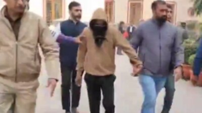Kumawat (32), in brown hoodie was produced before the Delhi court on Saturday (Twitter Photo) Kumawat (32), in brown hoodie was produced before the Delhi court on Saturday (Twitter Photo)