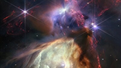 A look at Sun-like stars being born in this detailed close-up of Rho Ophiuchi, the closest-star-forming region to Earth in a composite image taken by the James Webb Telescope and released by NASA on July 12, 2023. Dark, dense dust cocoons still-forming protostars, while an emerging stellar newborn (top center) shoots out two huge jets of molecular hydrogen.&nbsp; (NASA via REUTERS)