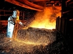 A worker in a protective suit pokes a metal rod to tap slag from a smelting furnace at a nickel processing plant in Indonesia (Representational picture) A worker in a protective suit pokes a metal rod to tap slag from a smelting furnace at a nickel processing plant in Indonesia (Representational picture)