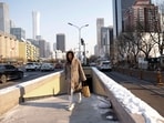 A woman walks on a street in Beijing's Central Business District (CBD) on a cold winter day.