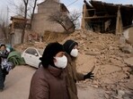 Residents pass by a house that crumbled after an earthquake in Dahejia town in northwestern China's Gansu province. Residents pass by a house that crumbled after an earthquake in Dahejia town in northwestern China's Gansu province.