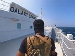 A Houthi fighter stands on the Galaxy Leader cargo ship in the Red Sea