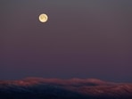 The full snow moon sets over a mountain range in northern Oxford County, near Andover, Maine. The full snow moon sets over a mountain range in northern Oxford County, near Andover, Maine.