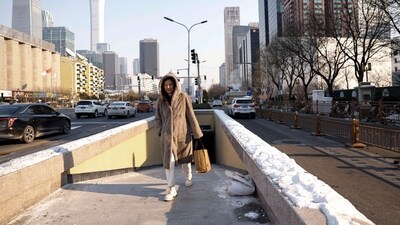 A woman walks on a street in Beijing's Central Business District (CBD) on a cold winter day. (REUTERS)