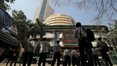 People look at a screen displaying the Sensex results on the facade of the Bombay Stock Exchange (BSE) building in Mumbai. (REUTERS)