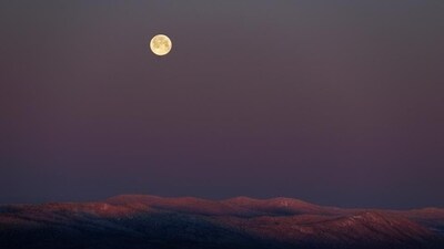 The full snow moon sets over a mountain range in northern Oxford County, near Andover, Maine. (AP) The full snow moon sets over a mountain range in northern Oxford County, near Andover, Maine. (AP)