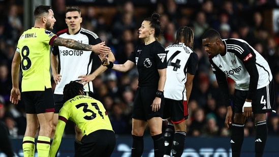 English referee Rebecca Welch speaks with Burnley's English midfielder #08 Josh Brownhill (L) during the English Premier League football match (AFP)
