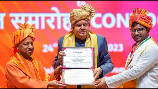 Vice President Jagdeep Dhankhar and Uttar Pradesh Chief Minister Yogi Adityanath at the Convocation Ceremony-2023 of Gautam Buddha University, in Noida, Sunday. (PTI)