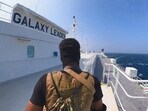 A Houthi fighter stands on the Galaxy Leader cargo ship in the Red Sea