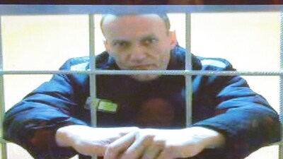 Russian opposition leader Alexei Navalny is seen on a screen via a video link during a court hearing. (Reuters)