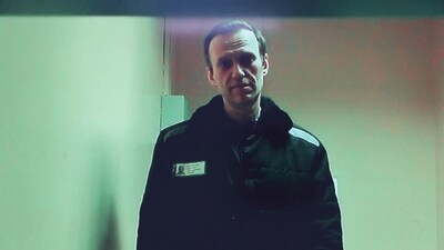Russian opposition leader Alexei Navalny is seen on a screen via video link from a penal colony. (Reuters)