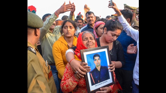 Family members mourn during cremation of Indian Army soldier Karan Yadav, who was recently killed in a militant attack in Kashmir, at his ancestral place Bhaupur, in Kanpur district, on Monday. (PTI)