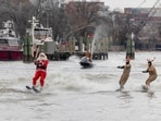 Performers dressed as Santa Claus and reindeers water-ski past crowds during the annual Christmas Eve performance by the "Waterskiing Santa" along the Old Town Alexandria Waterfront, from Founders Park to Point Lumley Park in Alexandria, Virginia, U.S., December 24, 2023. REUTERS/Amanda Andrade-Rhoades