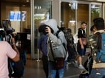 A passenger from Nicaragua bound Airbus A340 flight that was grounded in France on suspicion of human trafficking, evades the media as he leaves the Chhatrapati Shivaji Maharaj International Airport after his arrival, in Mumbai, 