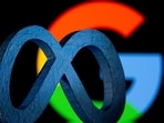 A 3D printed Facebook's new rebrand logo Meta is seen in front of displayed Google logo in this illustration.