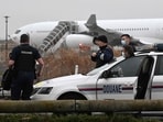 French customs officers stand next to a customs car with an Airbus A340 in the background which was grounded on the tarmac since December 21 over suspected "human trafficking", at the Vatry airport. French customs officers stand next to a customs car with an Airbus A340 in the background which was grounded on the tarmac since December 21 over suspected "human trafficking", at the Vatry airport.