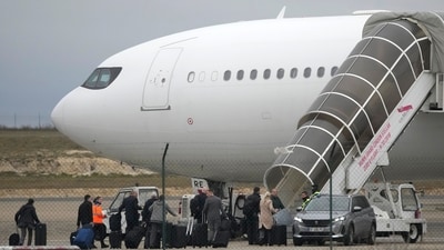 Crew members board the plane grounded by police at the Vatry airport on Monday. The plane landed in Mumbai shortly after 4 am on Tuesday. (AP) Crew members board the plane grounded by police at the Vatry airport on Monday. The plane landed in Mumbai shortly after 4 am on Tuesday. (AP)