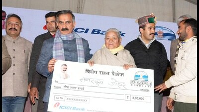 Himachal chief minister Sukvinder Singh Sukhu hands over a relief cheque to member of a disaster-hit family in Theog on Tuesday.