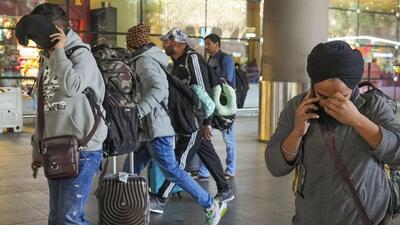 Passengers of a charter plane, which was grounded in France for four days over suspected human trafficking, arrive in Mumbai, on Dec. 26 (PTI) Passengers of a charter plane, which was grounded in France for four days over suspected human trafficking, arrive in Mumbai, on Dec. 26 (PTI)