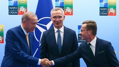 Turkey's President Recep Tayyip Erdogan, left, shakes hands with Sweden's Prime Minister Ulf Kristersson, right, as NATO Secretary General Jens Stoltenberg looks on prior to a meeting. (AP) Turkey's President Recep Tayyip Erdogan, left, shakes hands with Sweden's Prime Minister Ulf Kristersson, right, as NATO Secretary General Jens Stoltenberg looks on prior to a meeting. (AP)