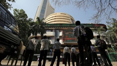 People look at a screen displaying the Sensex results on the facade of the Bombay Stock Exchange (BSE) building in Mumbai. (Reuters file)