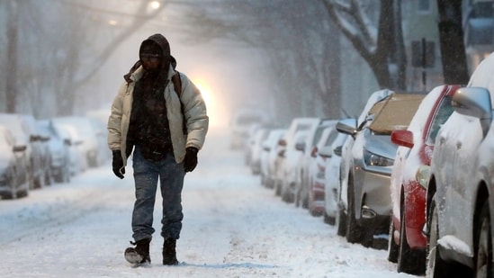 FILE - A man walks in the snow-covered street in Boston, Saturday, Jan. 29, 2022. (AP Photo/Michael Dwyer, File) (AP)
