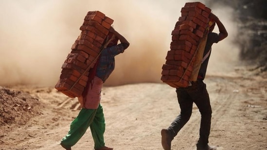 The report said human traffickers use debt-based coercion to force victims into low-paying jobs. (AFP)