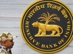 A security official walks past an emblem of the Reserve Bank of India at the RBI headquarters in Mumbai A security official walks past an emblem of the Reserve Bank of India at the RBI headquarters in Mumbai