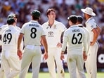 Australia's Pat Cummins (C) celebrates with teammates