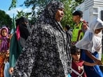 Rohingya refugees enter the compounds of a government building after demonstrating university students forced them to relocate from a previous government facility, in Banda Aceh. Rohingya refugees enter the compounds of a government building after demonstrating university students forced them to relocate from a previous government facility, in Banda Aceh.